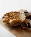 Whole grain loaf bread and wheat baguettefrench bread in basket with black coffee. Royalty Free Stock Photo