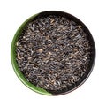 Whole-grain niger seeds in round bowl isolated