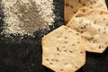 Whole grain organic cracker and flour on the black