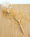 Whole grain soybeans in bottle and spoon on bamboo wooden board