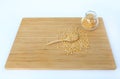 Whole grain soybeans in bottle and spoon on bamboo wooden board