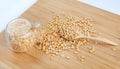 Whole grain soybeans in bottle and spoon on bamboo wooden board