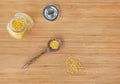 Whole grain soybeans in bottle and wooden spoon on bamboo wooden board, top view