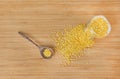 Whole grain soybeans in bottle and wooden spoon on bamboo wooden board, top view