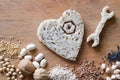 Whole grains products, groats, nuts, legumes, seeds on wooden background. Wrench, screw and heart made of bread, healthy heart die Royalty Free Stock Photo