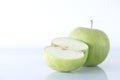 Whole green apple and a half one on a white background, isolated, macro photography Royalty Free Stock Photo