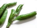 Whole green pea pods close-up isolated on a white background