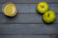 Whole green ripe apples autumn harvest and apple juice, from above a dark gray wooden table Royalty Free Stock Photo