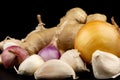 Whole group pile ingredient of fresh onion garlic ginger  isolated on black background Royalty Free Stock Photo