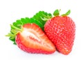 Whole and half cut strawberries and leaves isolated on a white