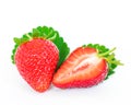 Whole and half cut strawberries and leaves isolated on a white