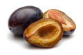 Whole and half Damson plums isolated on white Royalty Free Stock Photo