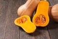 Whole and half fresh butternut squash on a wooden table Royalty Free Stock Photo