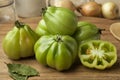 Whole and half gGreen Coeur de boeuf tomatoes Royalty Free Stock Photo