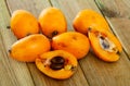 Whole and half fresh yellow loquat on wooden table