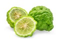 Whole and half of green fresh bergamot isolated on white