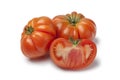 Organic whole and half Coeur de Boeuf tomatoes Royalty Free Stock Photo