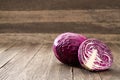 Whole and half purple cabbage on a wooden table, copy space for text