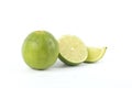 A whole, a half and a quarter of a lime isolated on white