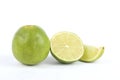 A whole, a half and a quarter of a lime isolated on white