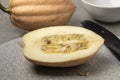 Whole and halved fresh Baked potato Acorn Squash on a cutting board Royalty Free Stock Photo