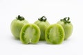 Whole and halved fresh green unripe tomatoes isolated on white background Royalty Free Stock Photo