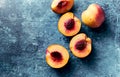 Whole and halved nectarines on rustic painted background