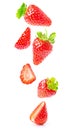 Whole and halved strawberries with vibrant red color and fresh green leaves, floating on a white background