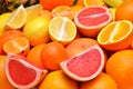 Whole and halves juicy tropical citrus fruits Royalty Free Stock Photo