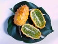 Whole and halves of a kiwano fruit on leaf Royalty Free Stock Photo