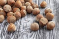 Whole hazelnuts scattered on wooden table