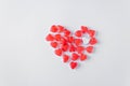 The whole heart consists of red heart-shaped jelly candies with one white jelly heart. White background. Valentine's