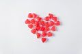 The whole heart consists of red heart-shaped jelly candies isolated on a white background. Valentine's Day concept.