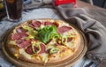 Whole italian pizza on textille table with ingredients stock photo