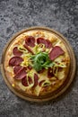 Whole italian pizza on textille table with ingredients stock photo