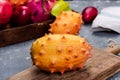 Whole Kiwano or Horned Melon Exotic Fruit on Cutting Board