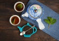 Whole leaf tea, teapot, two cups, mint Royalty Free Stock Photo