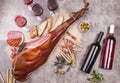 Whole leg HAM JAMON SERRANO and red and rose wine on gray background. Top view. Flat lay Royalty Free Stock Photo