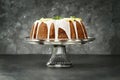 Whole Lemon Bundt Cake in Center of Dark Background