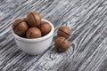 Whole macadamia nuts in white bowl Royalty Free Stock Photo