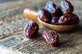 Whole medjool dates on a rustic wooden board with copy space to the left. Royalty Free Stock Photo