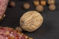A whole nutmeg on a black stone serving board Royalty Free Stock Photo