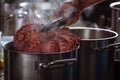 Whole octopus boiling in the the pot filled with water and vegetables. Tentacles of red octopus being boiled.