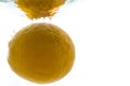 A whole orange thrown into the water. View from under the water Royalty Free Stock Photo