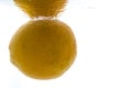A whole orange thrown into the water. View from under the water Royalty Free Stock Photo