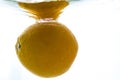 A whole orange thrown into the water. View from under the water Royalty Free Stock Photo