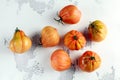 Whole organic tomatoes Coeur De Boeuf. Beefsteak tomato on white rustic table Royalty Free Stock Photo