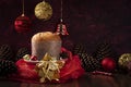 Whole panettone wrapped in red tulle,  background with red lights. Copy space Royalty Free Stock Photo