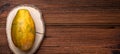 whole papaya on a wooden background. Banner, place for text