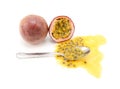 Whole passion fruit and half-eaten cross section with spoon